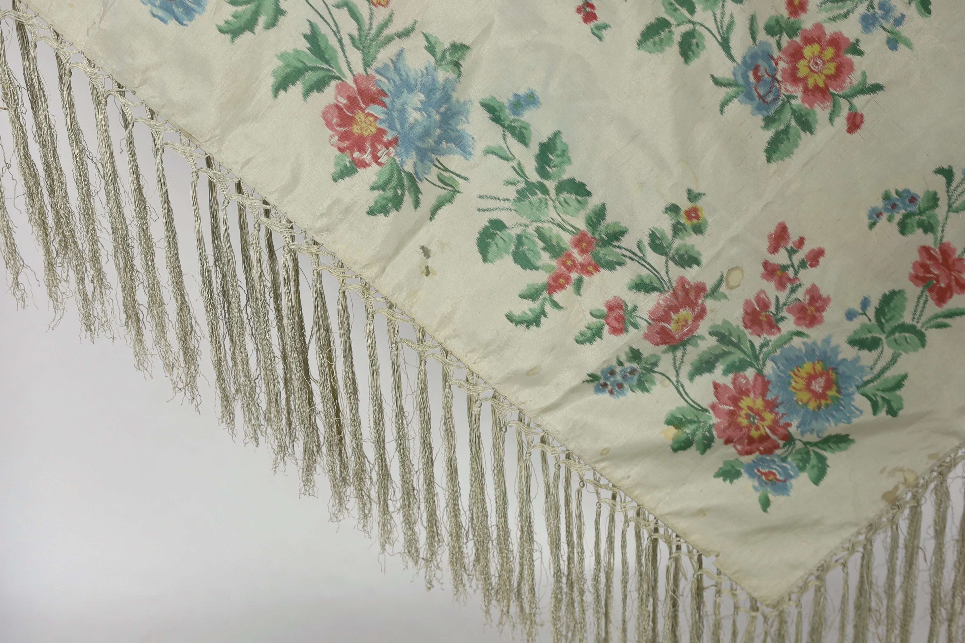 A French silk shawl, c.1800-1840, of a type modelled by Madame Recamier in the painting by François Gerard, printed on the warp thread into a rose pattern, with long fringing, 174 x 170cm